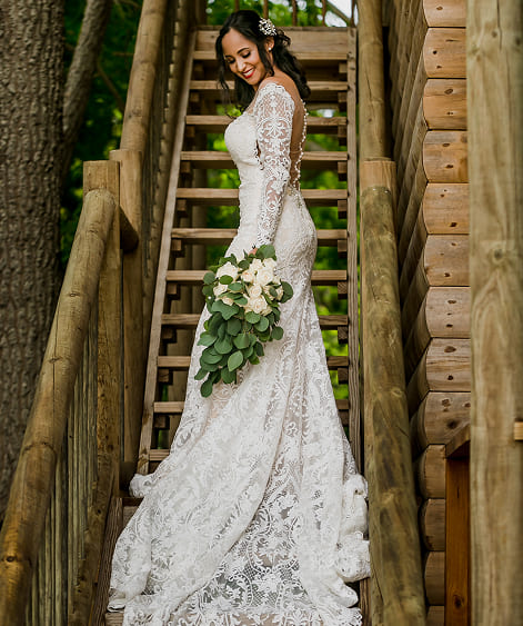 Novia en vestido blanco posando entre estructuras rústicas en ambiente natural de la isla
